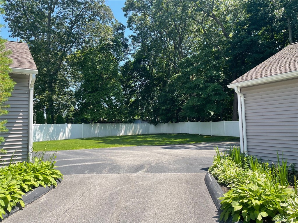 161 West Shore Road, Unit C7 Warwick, RI 02889 - Photo 5 of 36 Across from this unit's garage, there is this large grassy area.