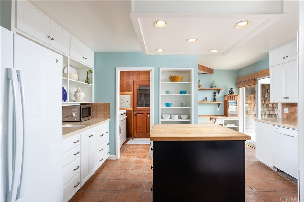 35811 Beach Road Dana Point, CA 92624 - Photo 15 of 41 a large kitchen with stainless steel appliances a sink and a refrigerator