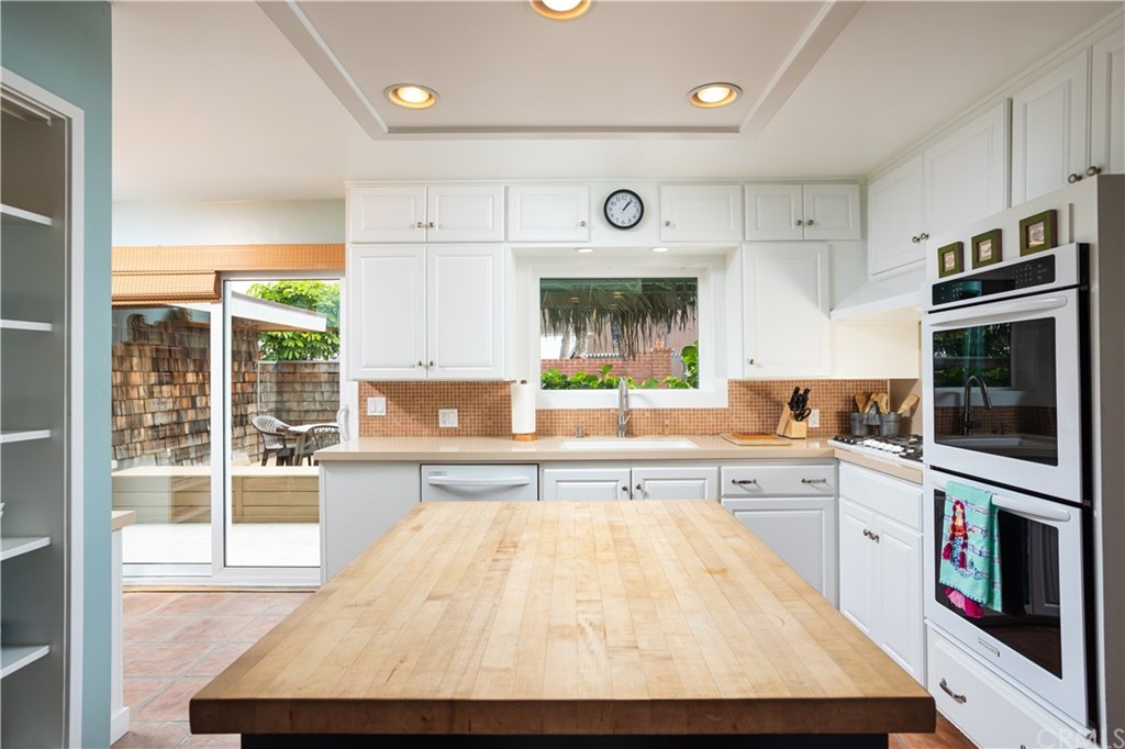 35811 Beach Road Dana Point, CA 92624 - Photo 16 of 41 a large kitchen with stainless steel appliances kitchen island granite countertop a refrigerator and a stove top oven