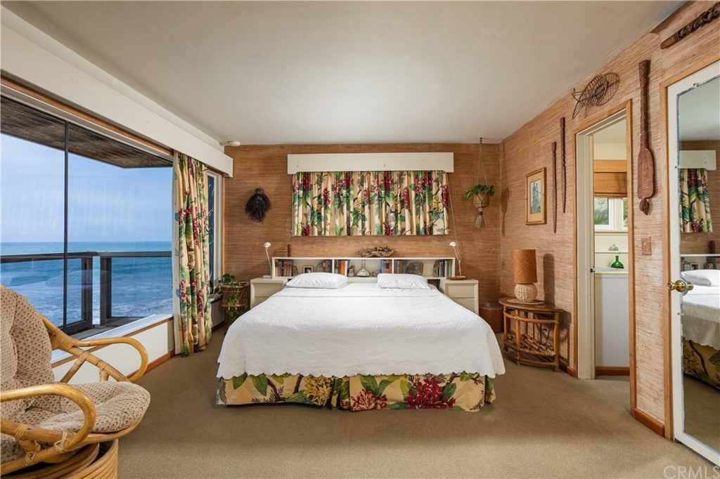 35811 Beach Road Dana Point, CA 92624 - Photo 20 of 41 a spacious bedroom with a bed and glass door