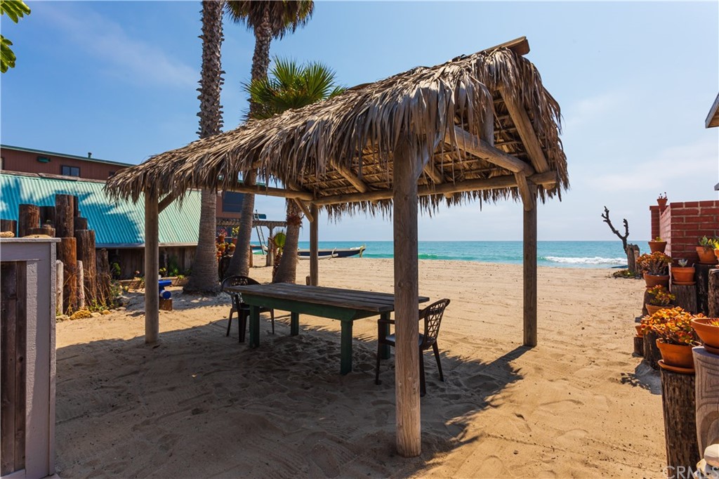 35811 Beach Road Dana Point, CA 92624 - Photo 2 of 41 a view of a swimming pool with a table and chairs under an umbrella