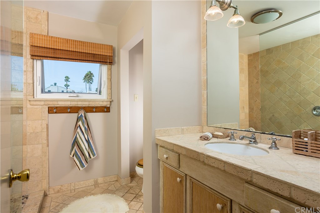 35811 Beach Road Dana Point, CA 92624 - Photo 21 of 41 a bathroom with a sink a toilet and shower