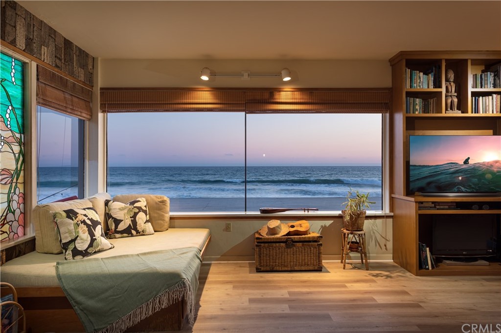 35811 Beach Road Dana Point, CA 92624 - Photo 35 of 41 a living room with furniture a flat screen tv and a floor to ceiling window