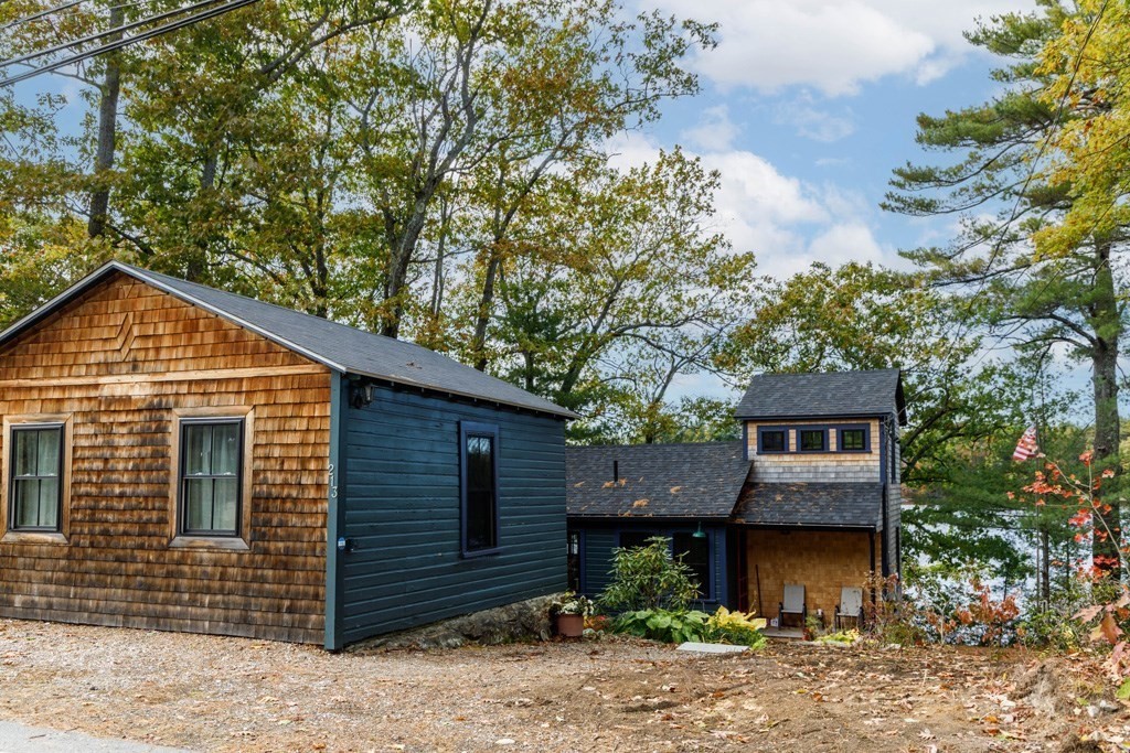 213 Ashby Road Ashburnham, MA 01430 - Photo 2 of 28 a front view of a house with a yard and garage