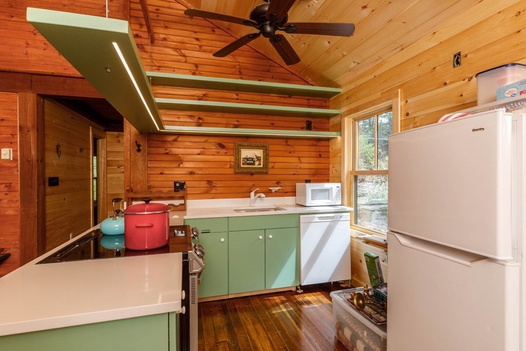 213 Ashby Road Ashburnham, MA 01430 - Photo 4 of 28 a kitchen with a refrigerator and a wooden floor