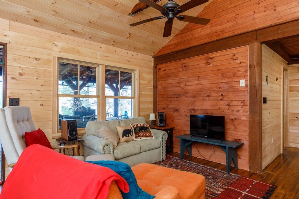 213 Ashby Road Ashburnham, MA 01430 - Photo 7 of 28 a living room with furniture a fireplace and a flat screen tv