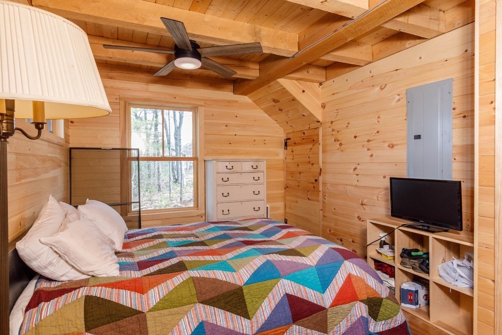 213 Ashby Road Ashburnham, MA 01430 - Photo 9 of 28 a bedroom with a bed and a flat screen tv