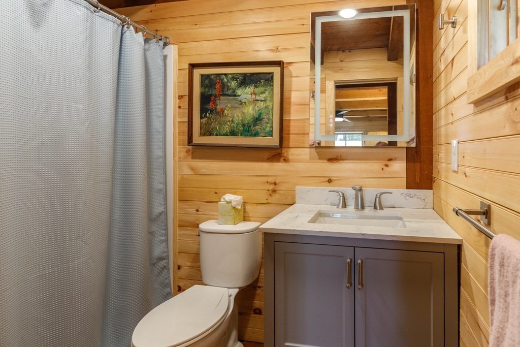 213 Ashby Road Ashburnham, MA 01430 - Photo 10 of 28 a bathroom with a toilet sink vanity and mirror