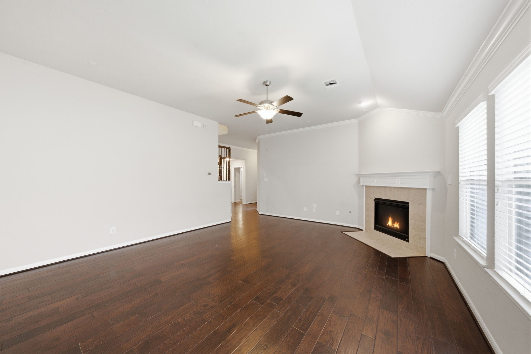 7611 Willow School Drive Spring, TX 77389 - Photo 7 of 23 an empty room with wooden floor fireplace and windows