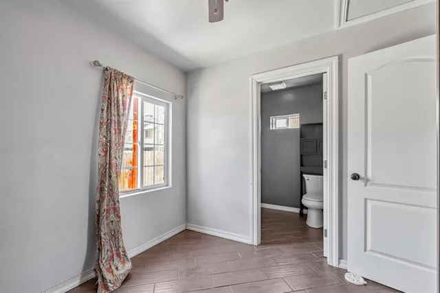 an empty room that has a window and a bathroom