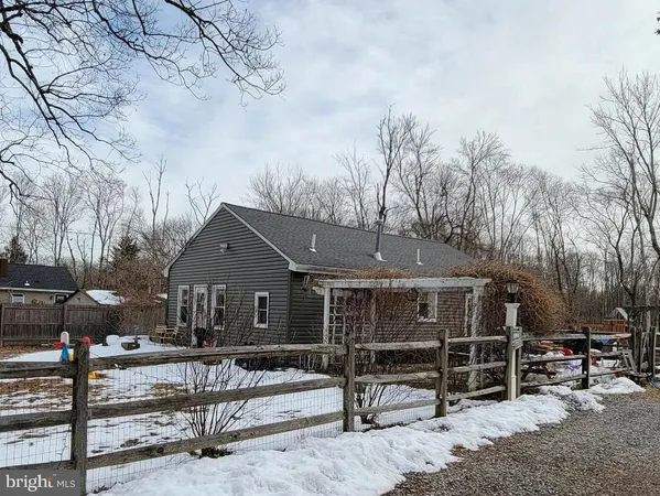 a front view of a house with a tree