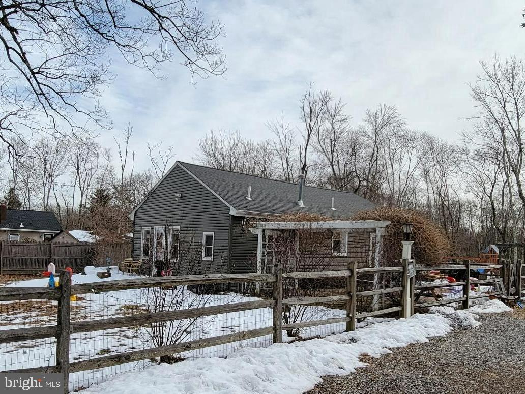 a front view of a house with a tree