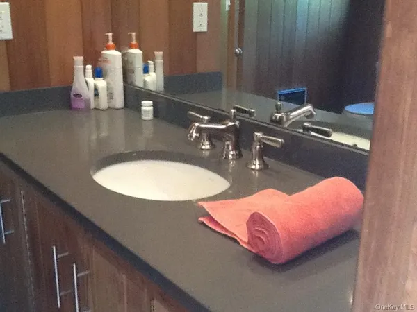 a bathroom with a double vanity sink and a mirror