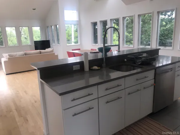 a kitchen with a sink and large window