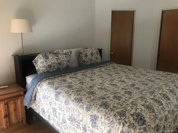 a bed sitting in a bedroom next to a lamp