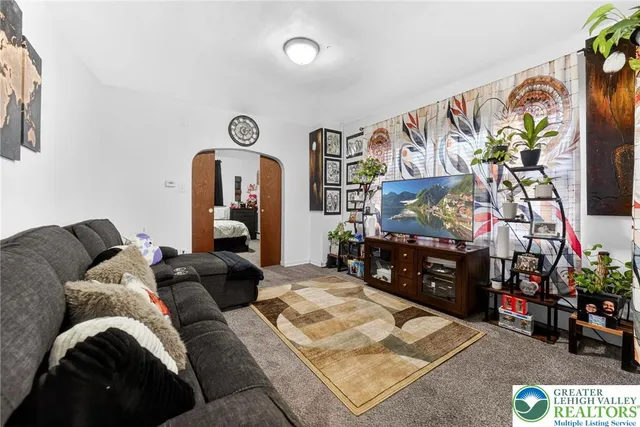 a living room with furniture and a flat screen tv