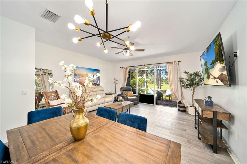816 Hampton Circle Naples, FL 34105 - Photo 11 of 49 a living room with furniture large window and wooden floor