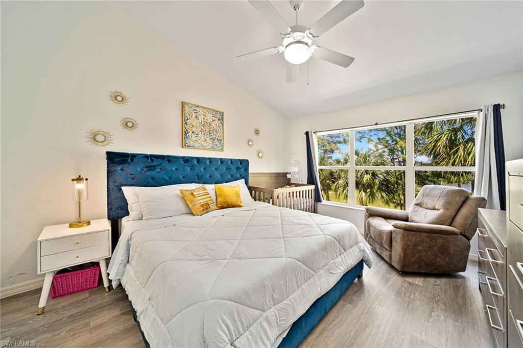 816 Hampton Circle Naples, FL 34105 - Photo 13 of 49 a bedroom with a large bed and a large window