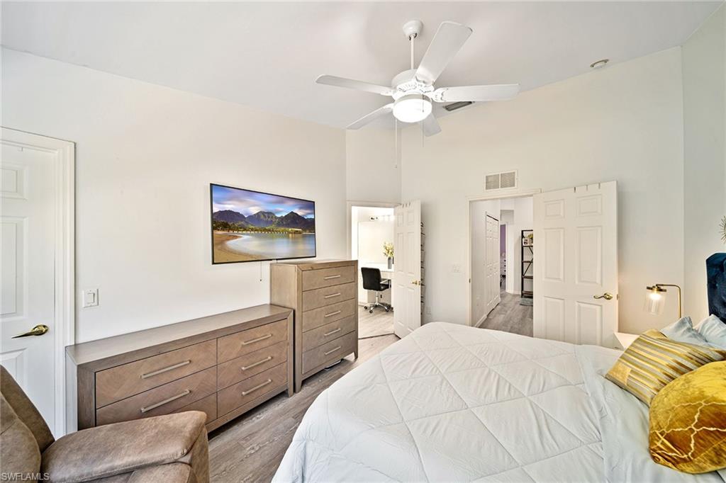 816 Hampton Circle Naples, FL 34105 - Photo 14 of 49 a bedroom with a bed and a chandelier