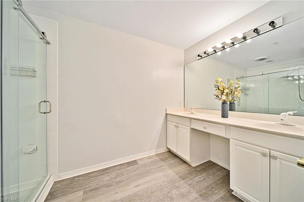 816 Hampton Circle Naples, FL 34105 - Photo 17 of 49 a bathroom with a sink and a mirror