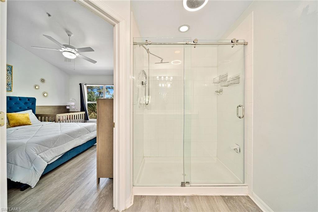 816 Hampton Circle Naples, FL 34105 - Photo 18 of 49 a bedroom with a bed and a chandelier