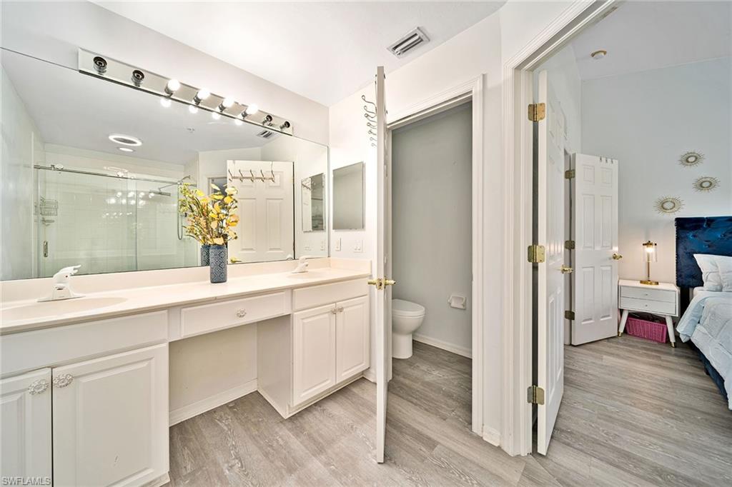 816 Hampton Circle Naples, FL 34105 - Photo 19 of 49 a spacious bathroom with a double vanity sink a mirror and a shower