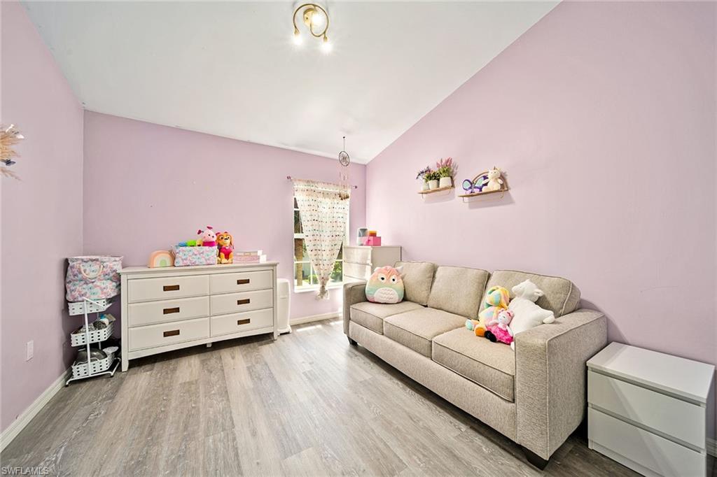 816 Hampton Circle Naples, FL 34105 - Photo 20 of 49 a living room with furniture and a baby crib