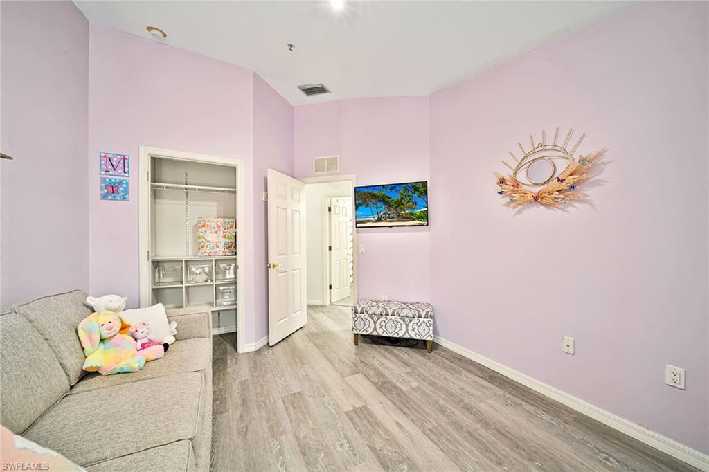 816 Hampton Circle Naples, FL 34105 - Photo 22 of 49 a living room with furniture and wooden floor