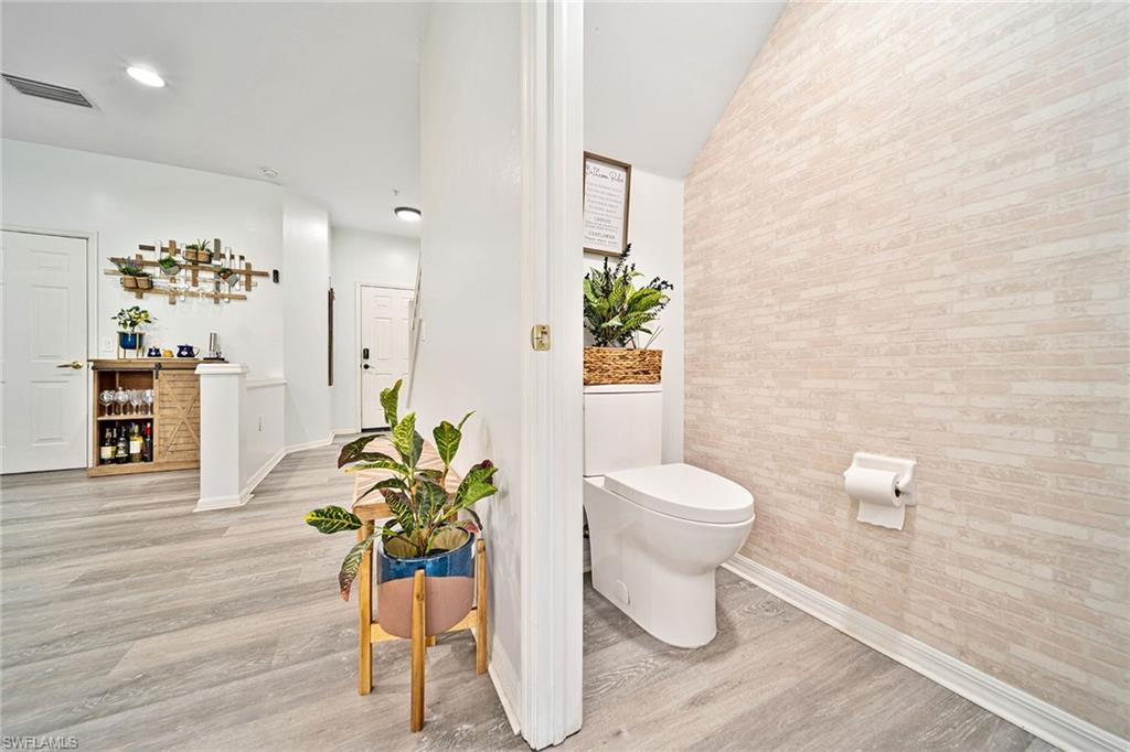 816 Hampton Circle Naples, FL 34105 - Photo 23 of 49 a bathroom with a toilet a sink and a mirror