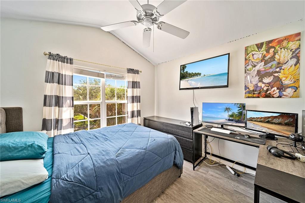 816 Hampton Circle Naples, FL 34105 - Photo 25 of 49 a bedroom with a bed and a flat screen tv