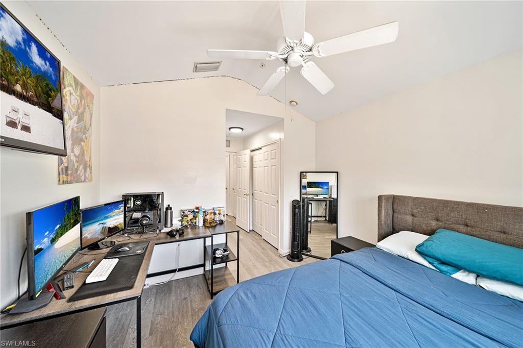 816 Hampton Circle Naples, FL 34105 - Photo 26 of 49 a bedroom with a bed and a chandelier