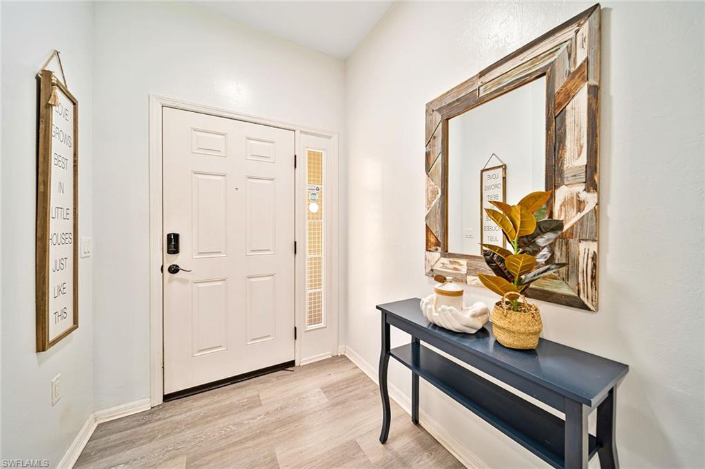 816 Hampton Circle Naples, FL 34105 - Photo 30 of 49 a living room with furniture and wooden floor