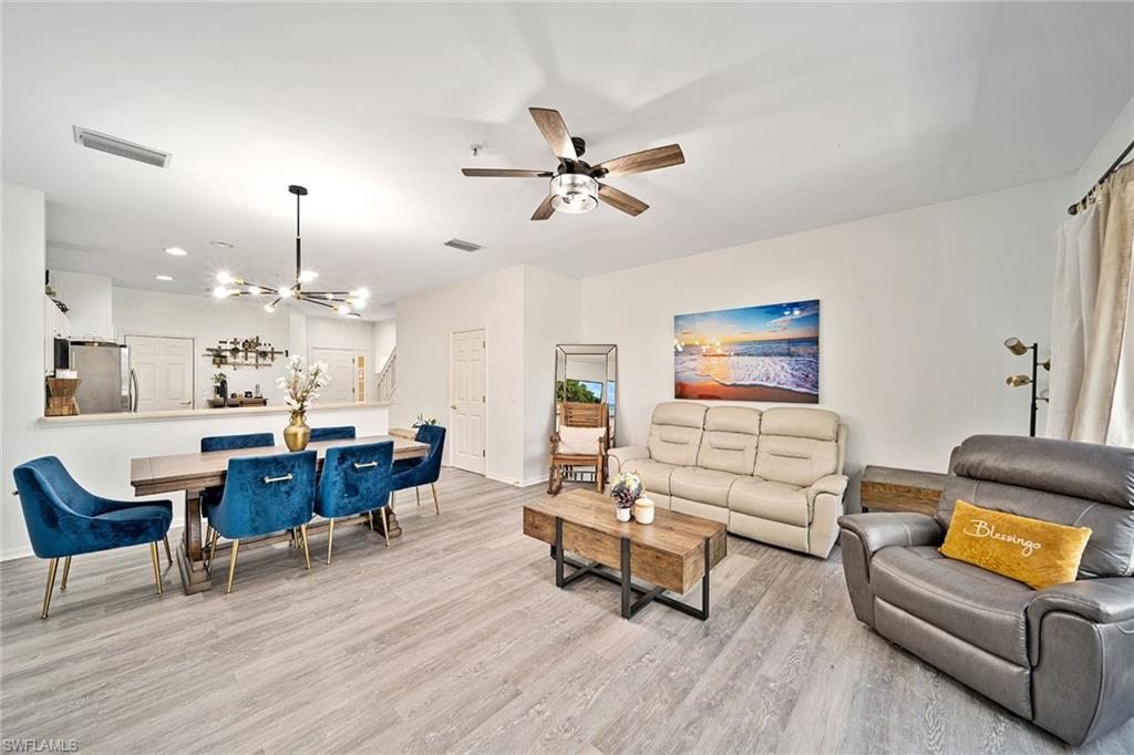 816 Hampton Circle Naples, FL 34105 - Photo 3 of 49 a living room with furniture and kitchen view