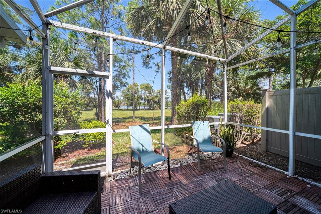 816 Hampton Circle Naples, FL 34105 - Photo 32 of 49 a view of a chair and tables in the balcony