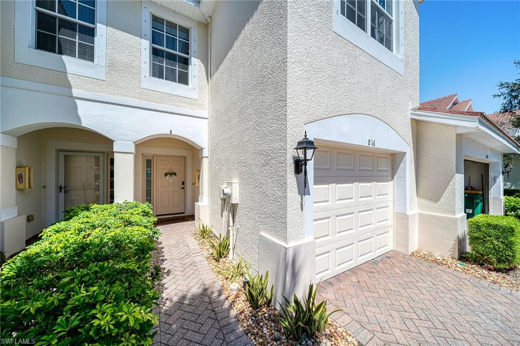 816 Hampton Circle Naples, FL 34105 - Photo 34 of 49 a front view of a house with a yard