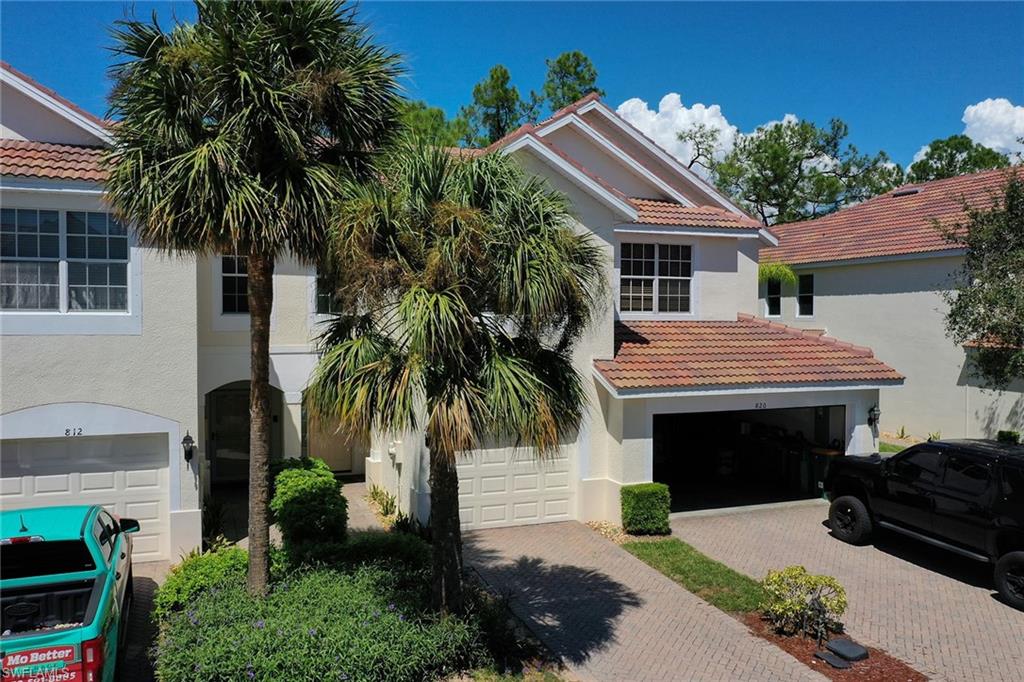 816 Hampton Circle Naples, FL 34105 - Photo 35 of 49 a front view of a house with a garden