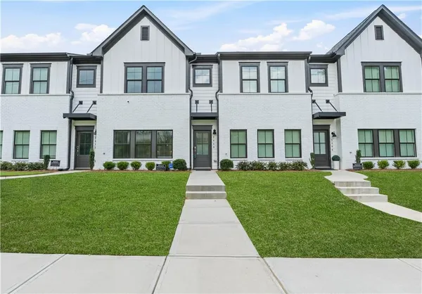 a front view of a house with a yard