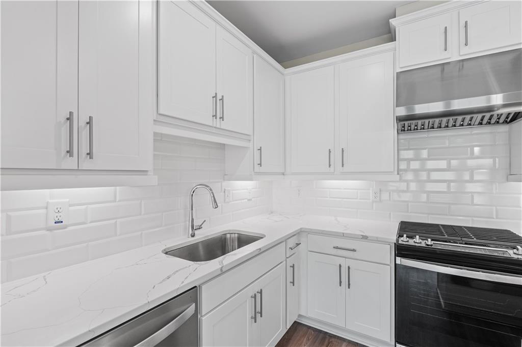 2410 Lakeshore Lane Atlanta, GA 30316 - Photo 12 of 31 a kitchen with white cabinets and appliances