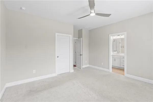 a view of an empty room and a ceiling fan