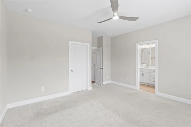 a view of an empty room and a ceiling fan