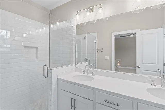 a bathroom with a sink double vanity and shower
