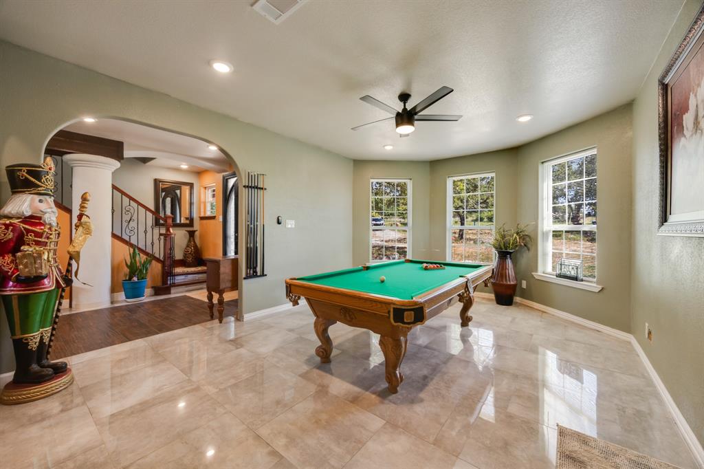 2277 County Road 3657 Springtown, TX 76082 - Photo 16 of 40 a room with pool tables and windows