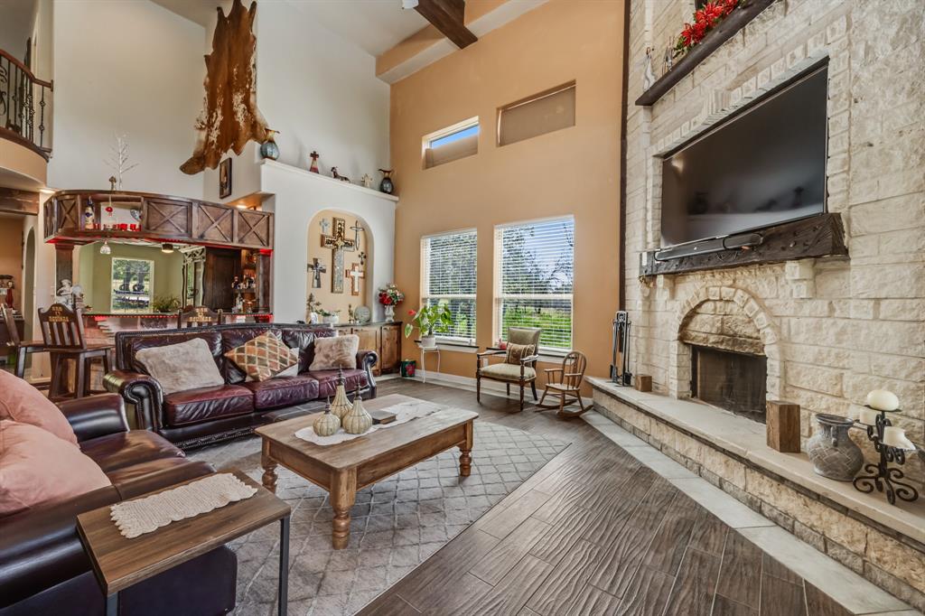 2277 County Road 3657 Springtown, TX 76082 - Photo 19 of 40 a living room with fireplace furniture and a flat screen tv