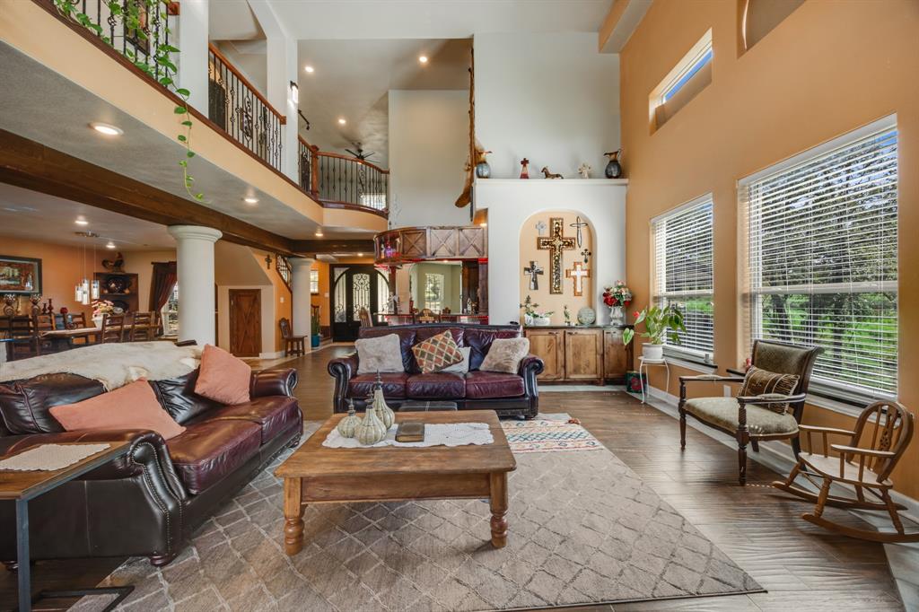 2277 County Road 3657 Springtown, TX 76082 - Photo 20 of 40 a living room with furniture fireplace and large windows