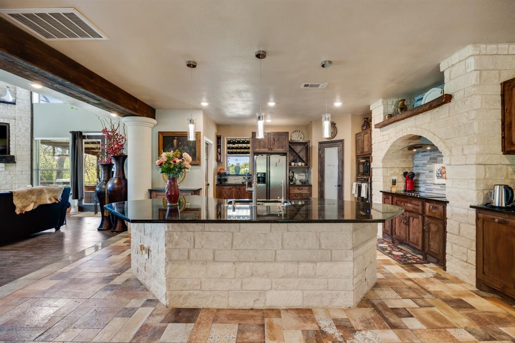 2277 County Road 3657 Springtown, TX 76082 - Photo 23 of 40 a large living room with stainless steel appliances kitchen island granite countertop furniture and a view of kitchen
