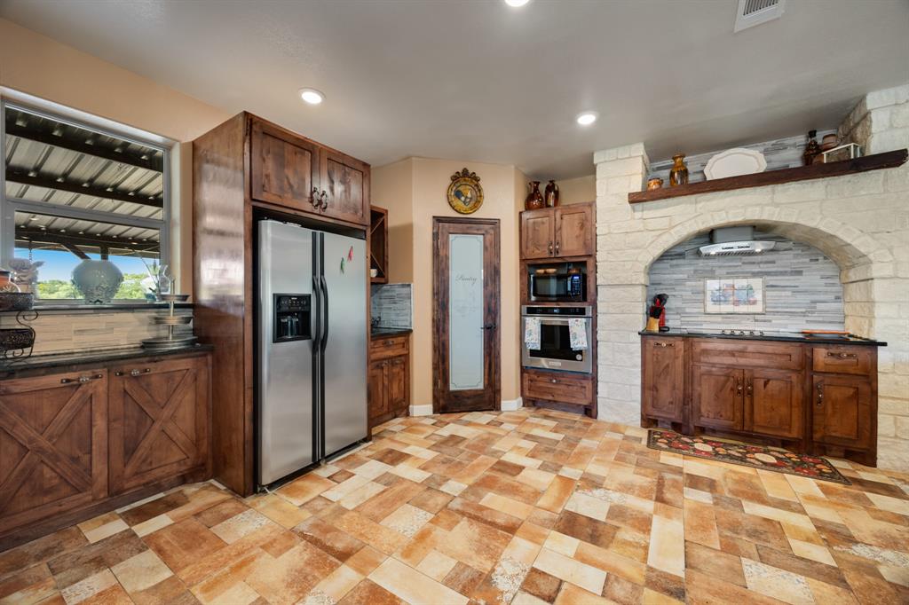 2277 County Road 3657 Springtown, TX 76082 - Photo 26 of 40 a view of a kitchen with a sink