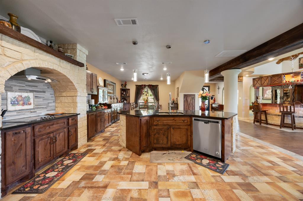 2277 County Road 3657 Springtown, TX 76082 - Photo 27 of 40 a view of kitchen with sink and living room