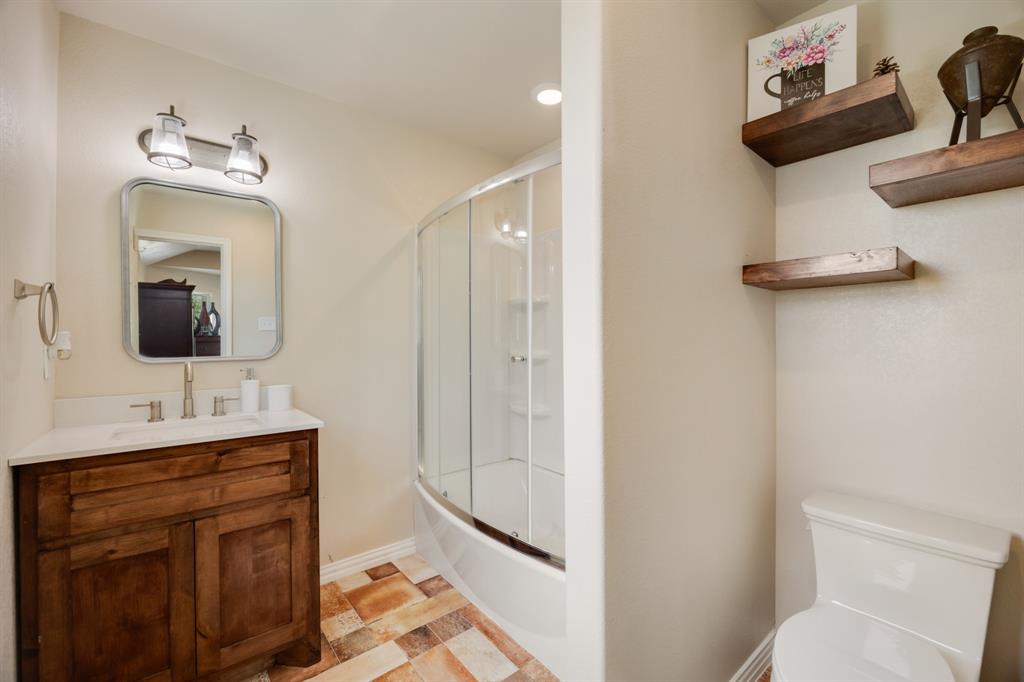 2277 County Road 3657 Springtown, TX 76082 - Photo 33 of 40 a bathroom with a toilet sink and mirror
