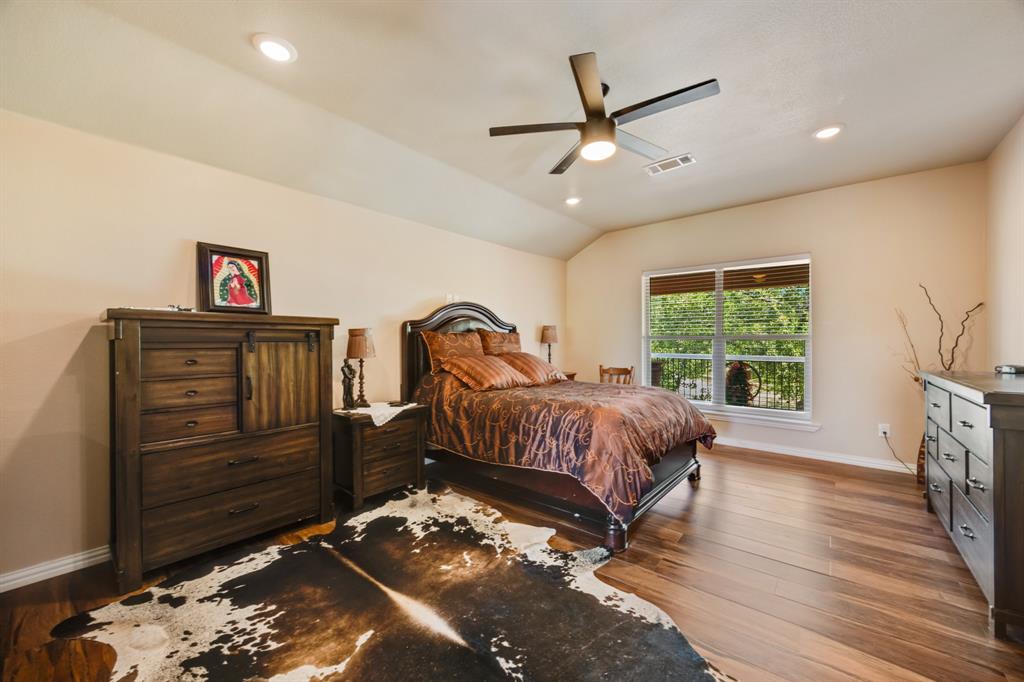 2277 County Road 3657 Springtown, TX 76082 - Photo 34 of 40 a bedroom with a bed and a dresser