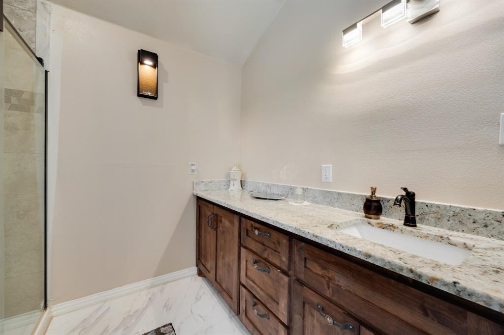 2277 County Road 3657 Springtown, TX 76082 - Photo 36 of 40 a bathroom with a sink and a mirror